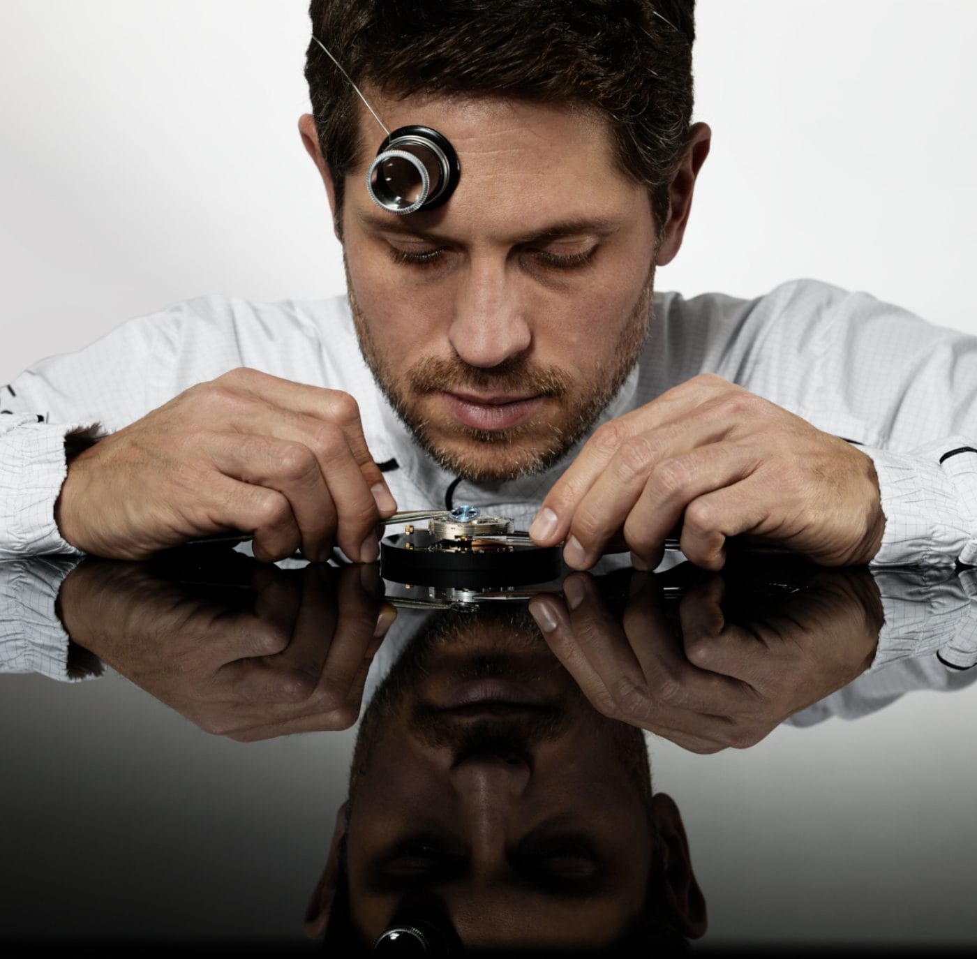 IWC watchmaker in uniform servicing a watch