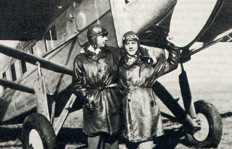 Black and white photo showing two mean in front of an aircraft,Black and white photo showing two mean in front of an aircraft