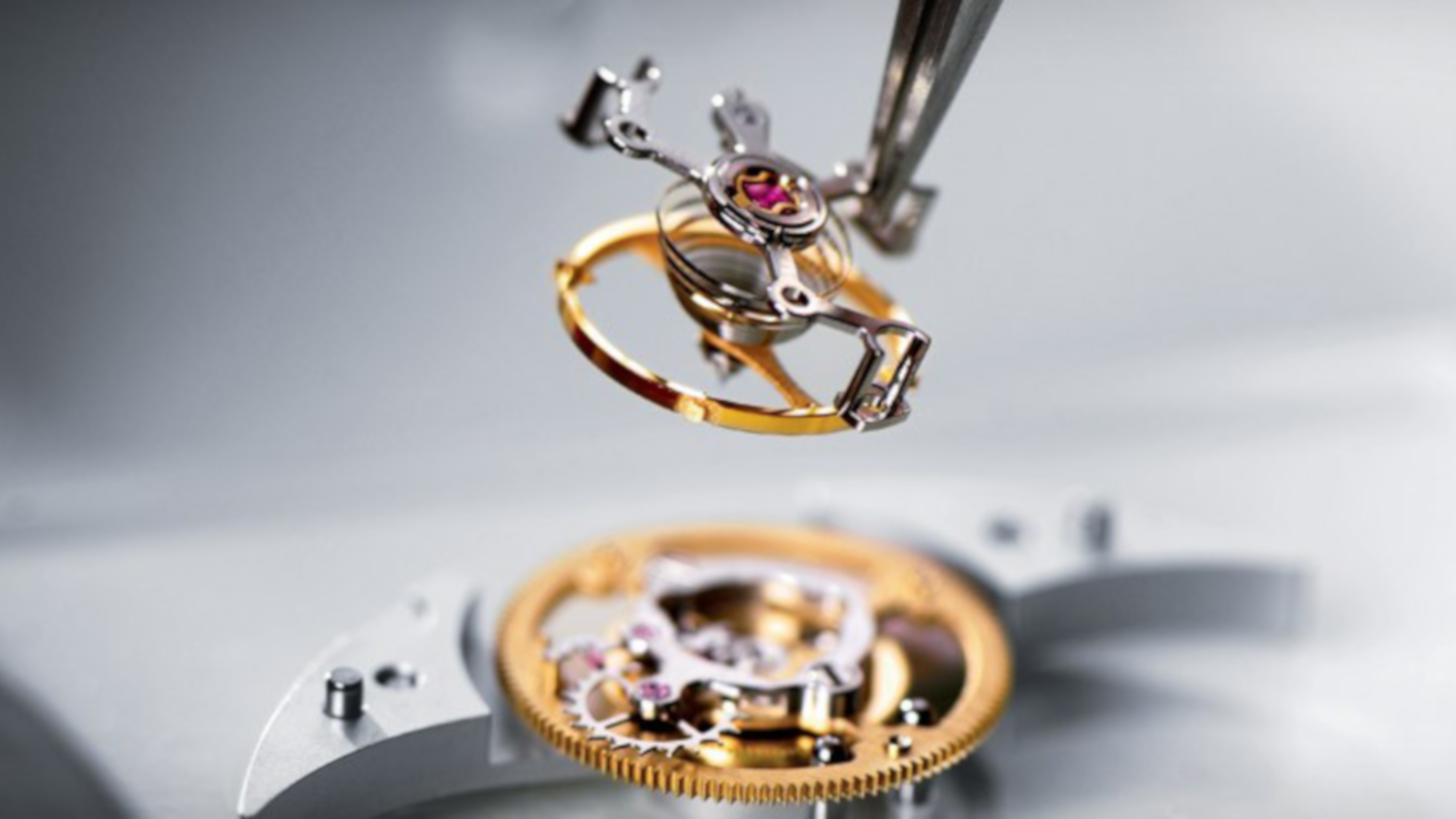 Close up of putting elements of a watch together